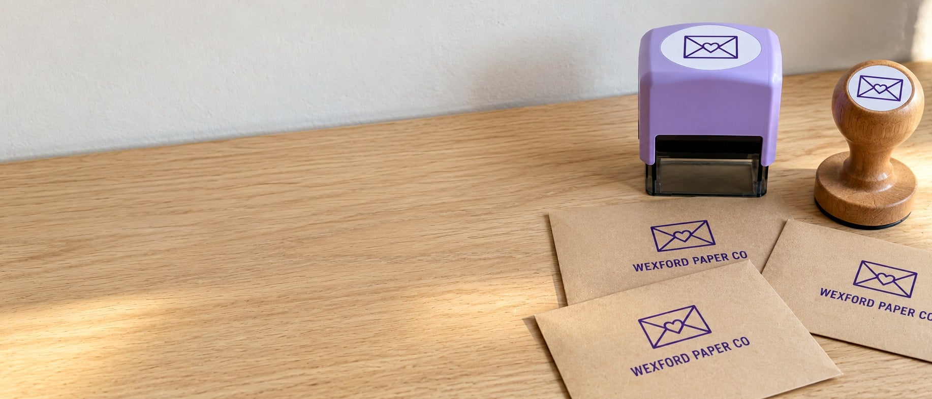 Custom self-inking address stamps and stamped envelopes on a desk